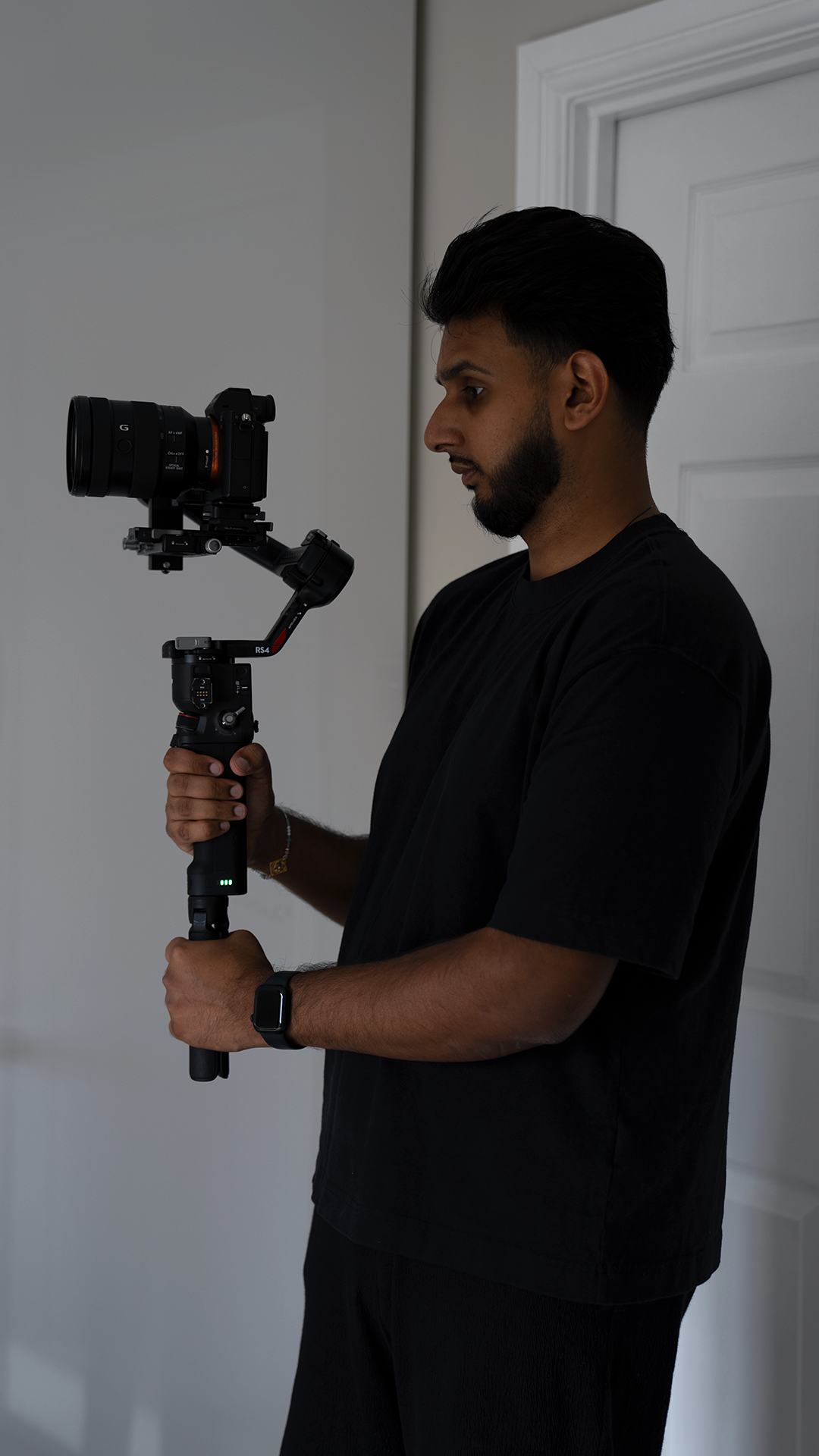 Dhanesh capturing a bride’s getting‑ready moments with a Sony mirrorless camera and DJI stabiliser — quiet, steady and storytelling from the very first frame