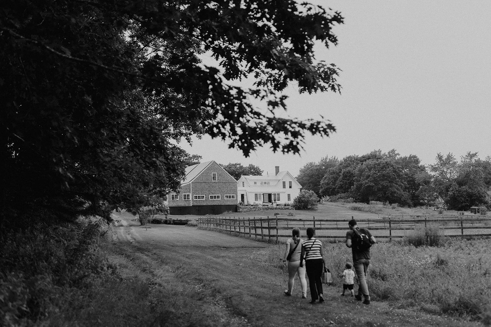 wedding guests making their way to the ceremony at tops'l farm wedding venue