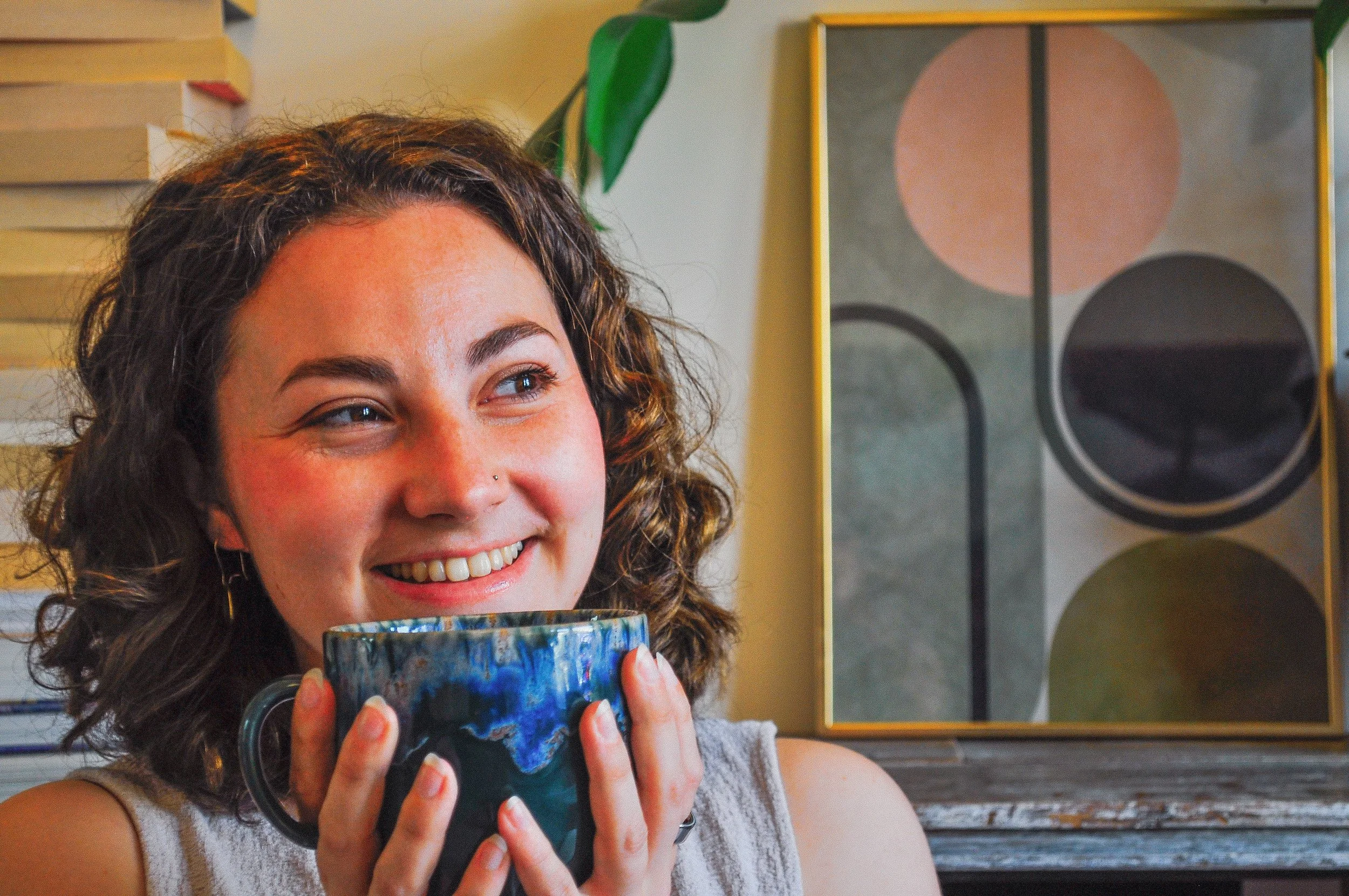 Chloe headshot smiling and holding a mug