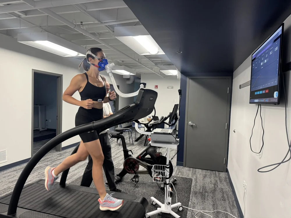A client running on the Woodway treadmill with a breath mask during a VO2 Max test at DexaFit Tampa