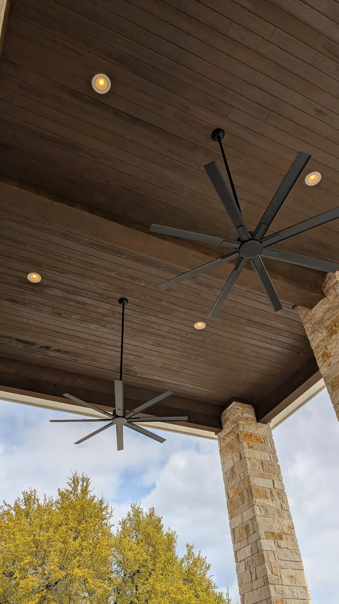 Back porch ceiling featuring embedded lights and ceiling fans that were installed by BP Electrical Services