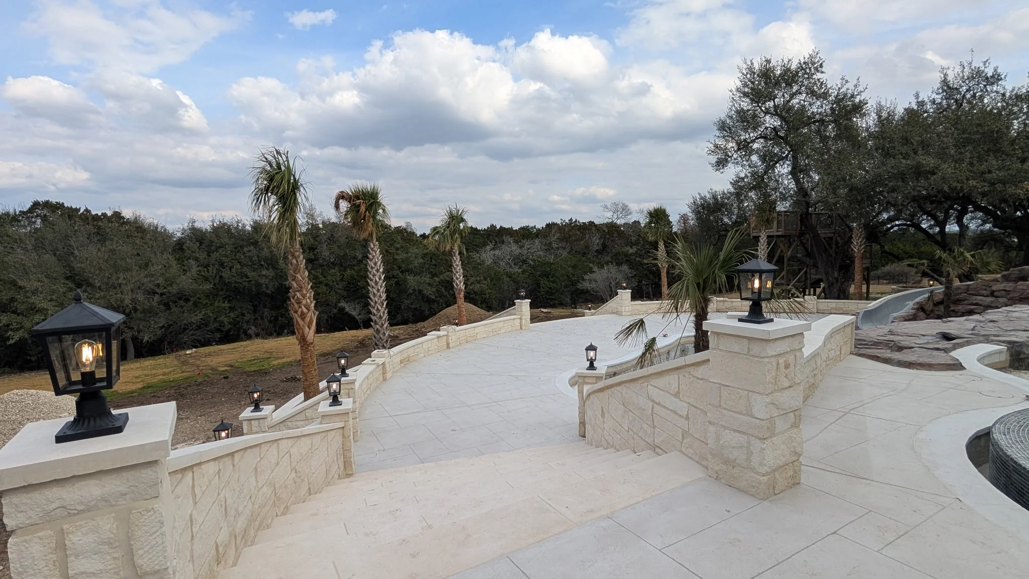 Outdoor lighting on a walkway in a large backyard, installed by BP Electrical Services