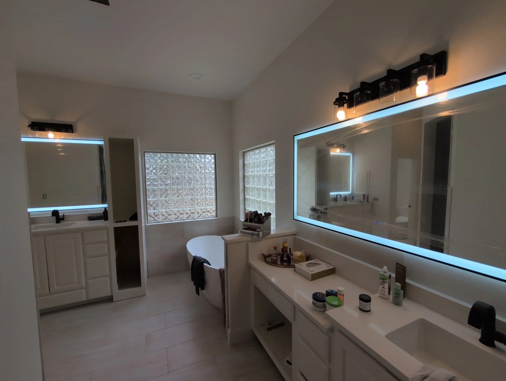 Bathroom lighting installed by BP Electrical Services, featuring lighted mirrors