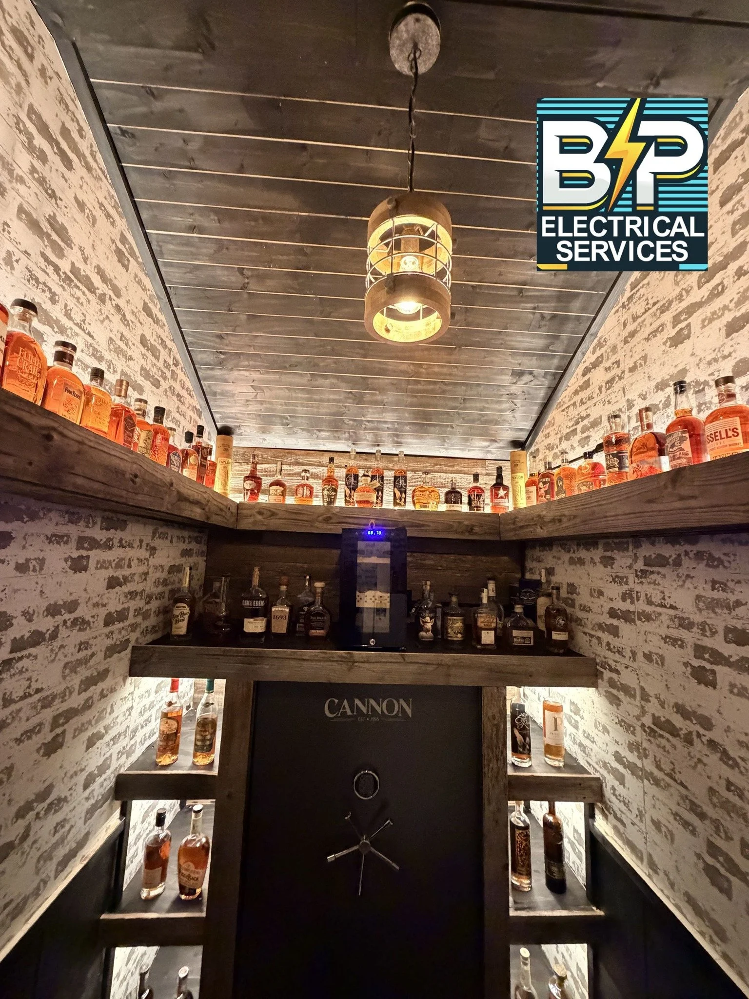 Residential liquor room featuring top shelf whiskey and shelf lighting installed by BP Electrical Services