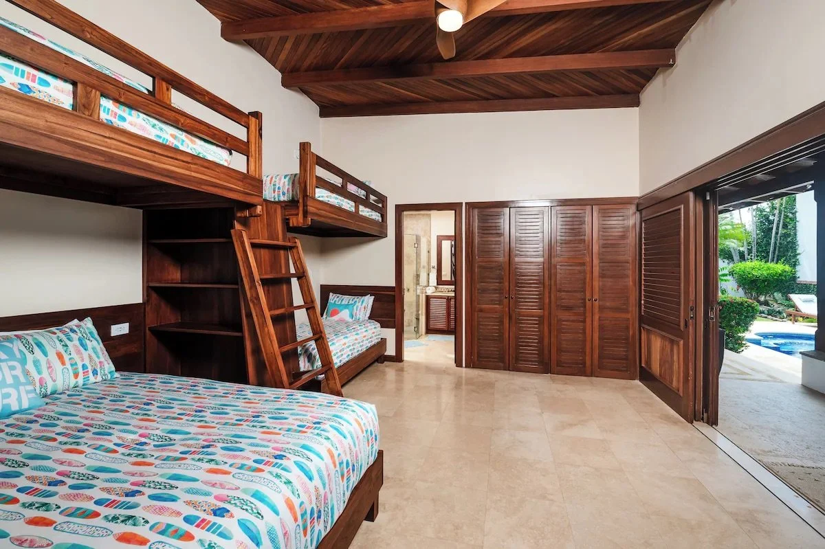 Custom bunk room with storage and a reading light for each bed