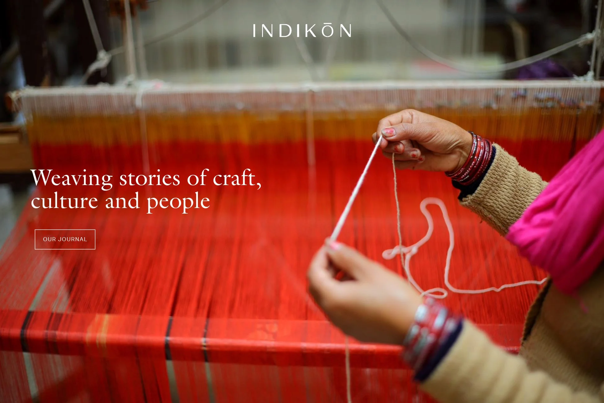 indikon image of hand weaving red thread