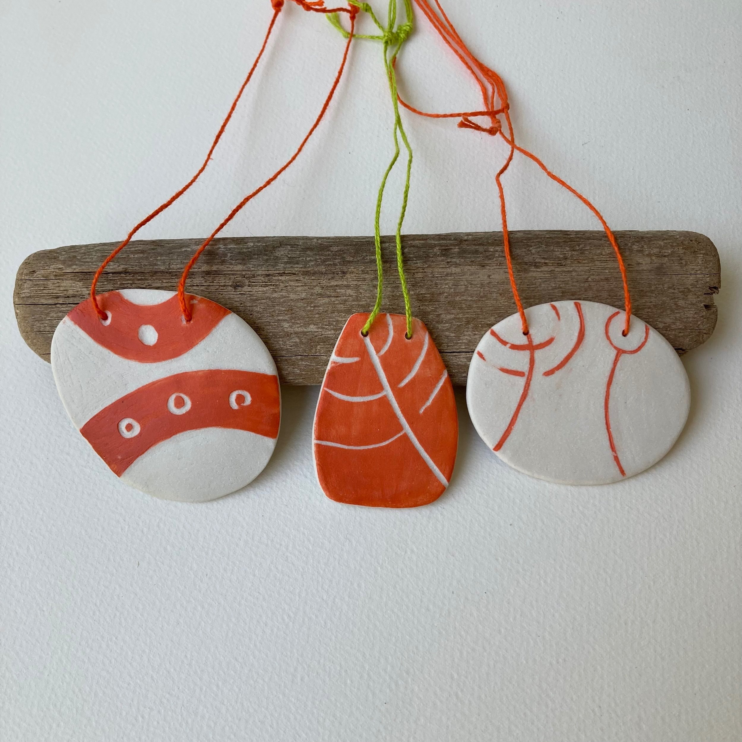 Porcelain pendant handmade with Neolithic inspired decorations. Bold and bright with linen cord.
