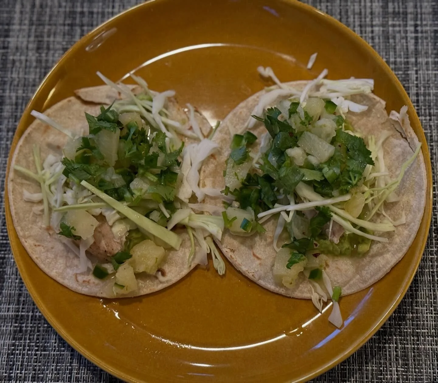 My husband (who is generally not a fish fan) says these were his favorite fish tacos ever! I marinated a swordfish steak in lime juice with cumin and chilis, then grilled it. Guacamole, shredded cabbage, fish, and the main flavor ingredient was pinea