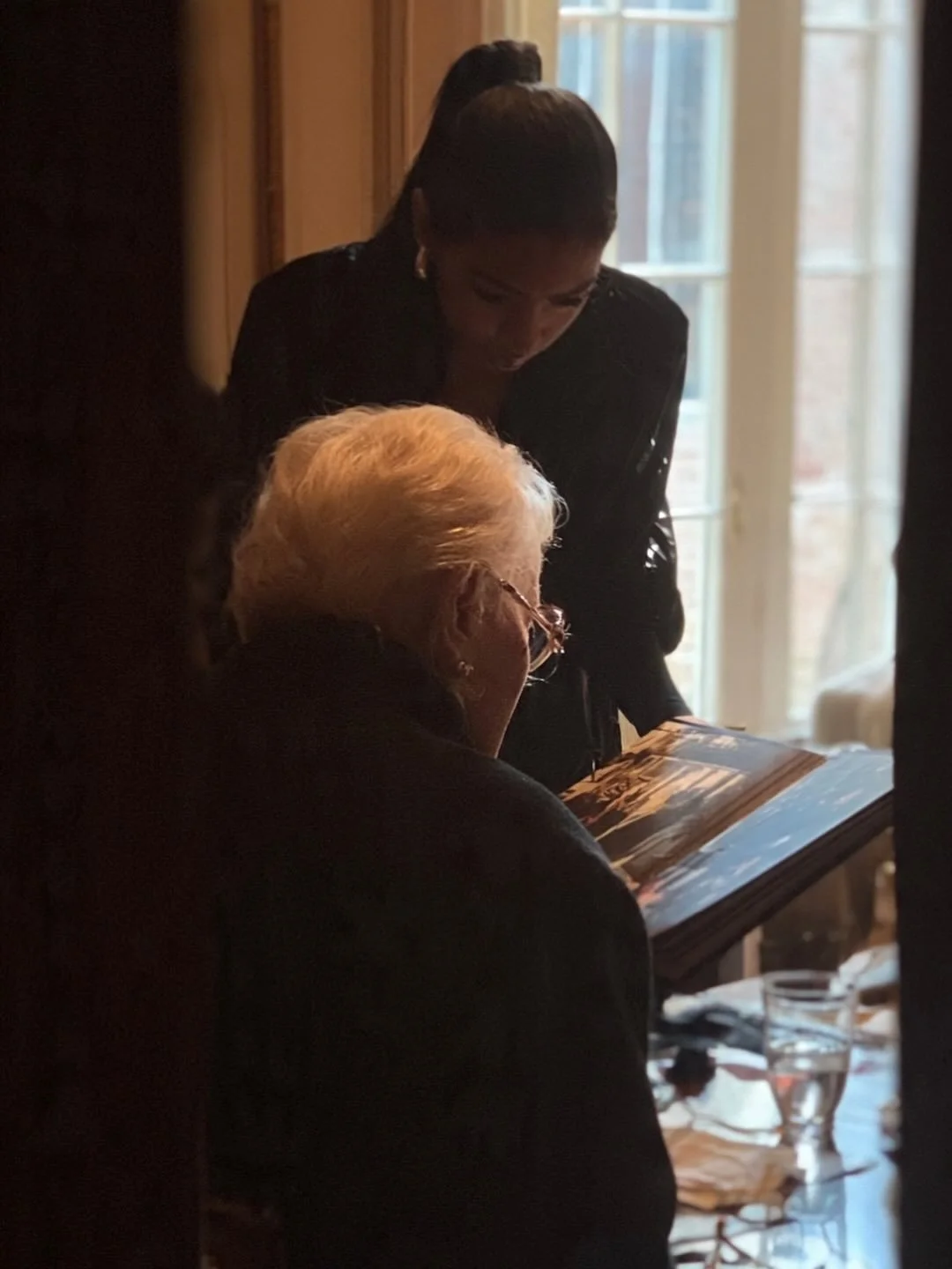 Looking through old photographs, sharing stories, and revisiting familiar memories.
