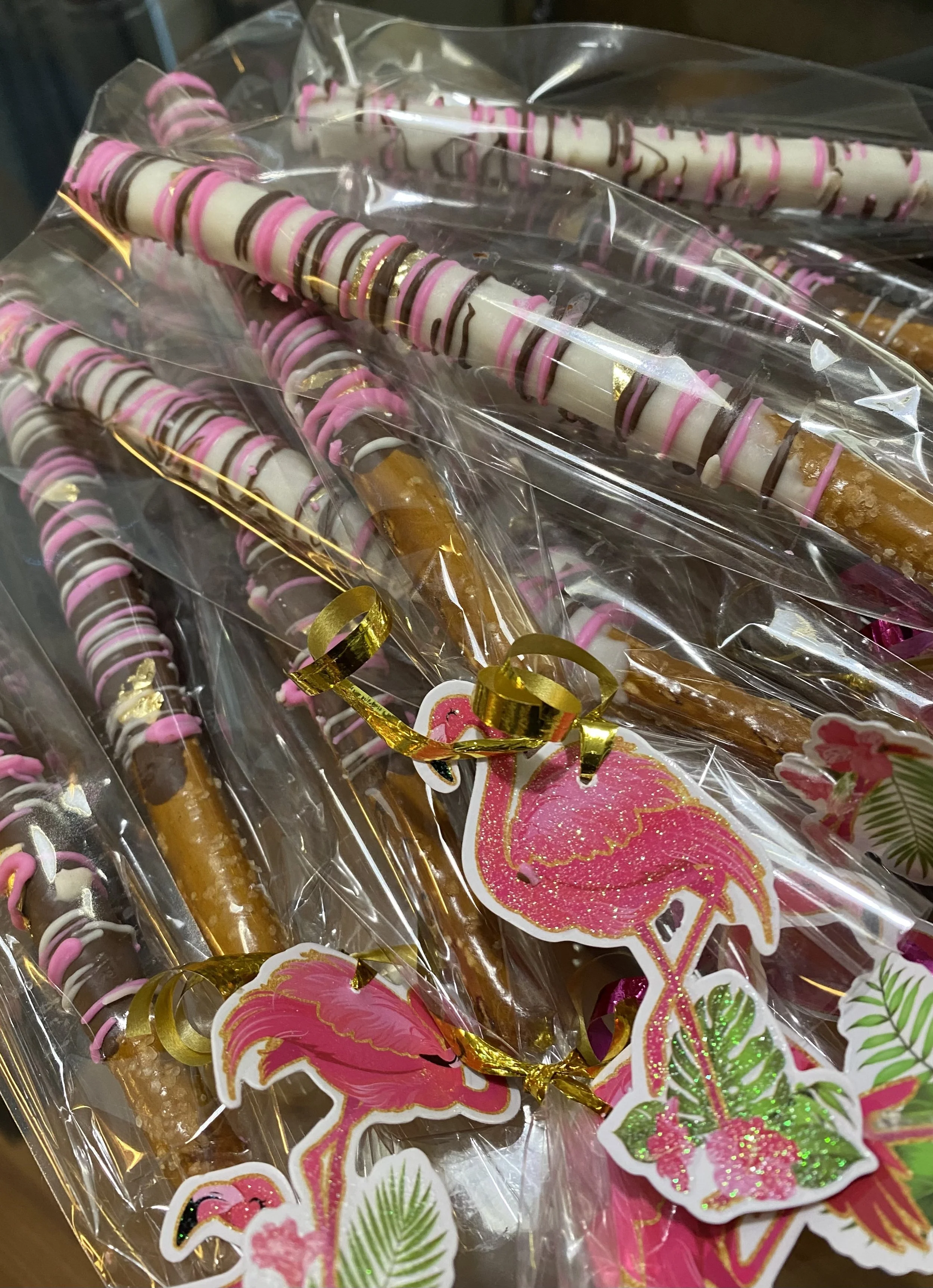 Colorful party horns and flamingo-shaped decorations wrapped in clear plastic.