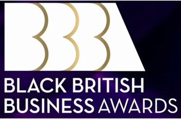 Logo for the Black British Business Awards with gold and white design elements and text.