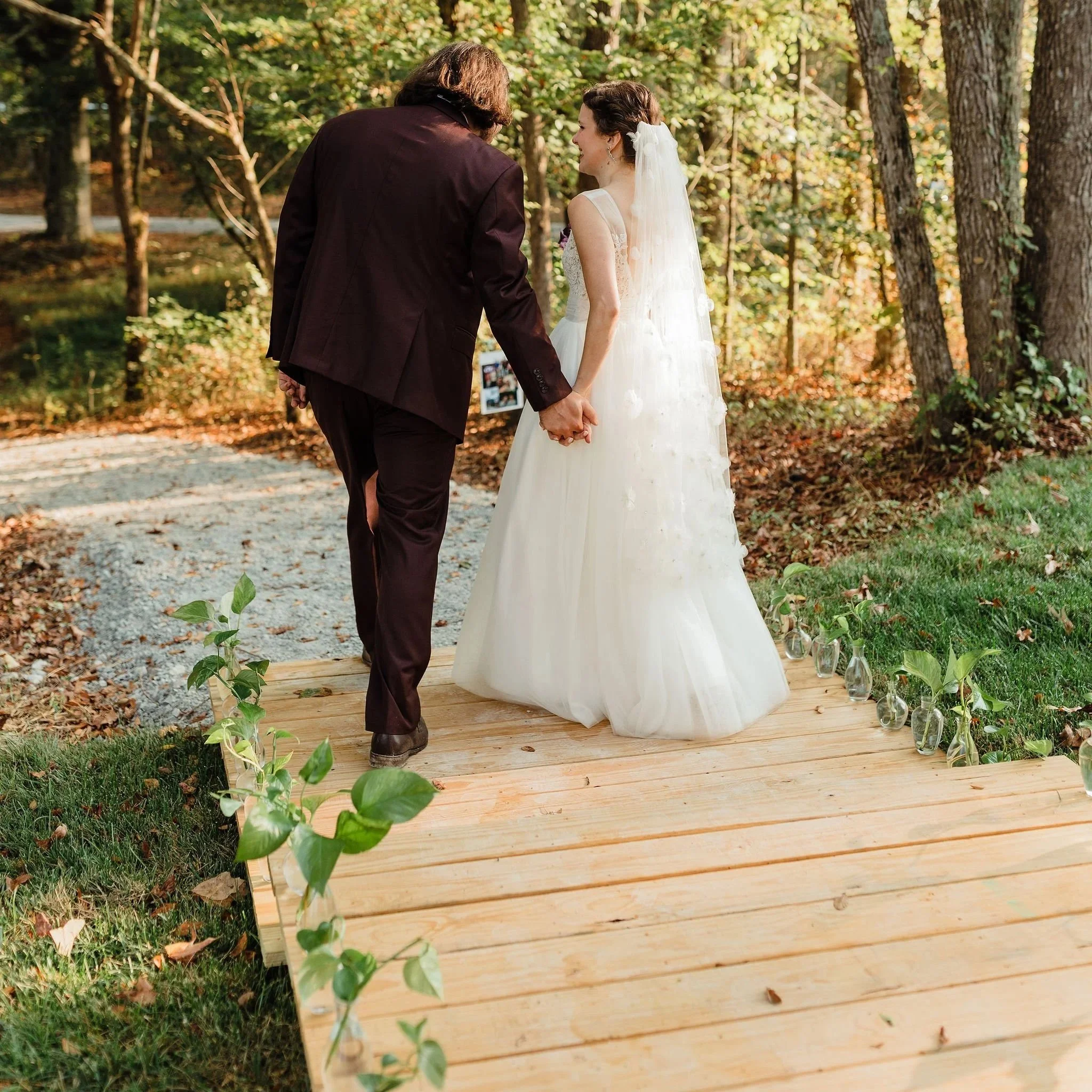 greenery lining a wedding isle in a whimsical setting