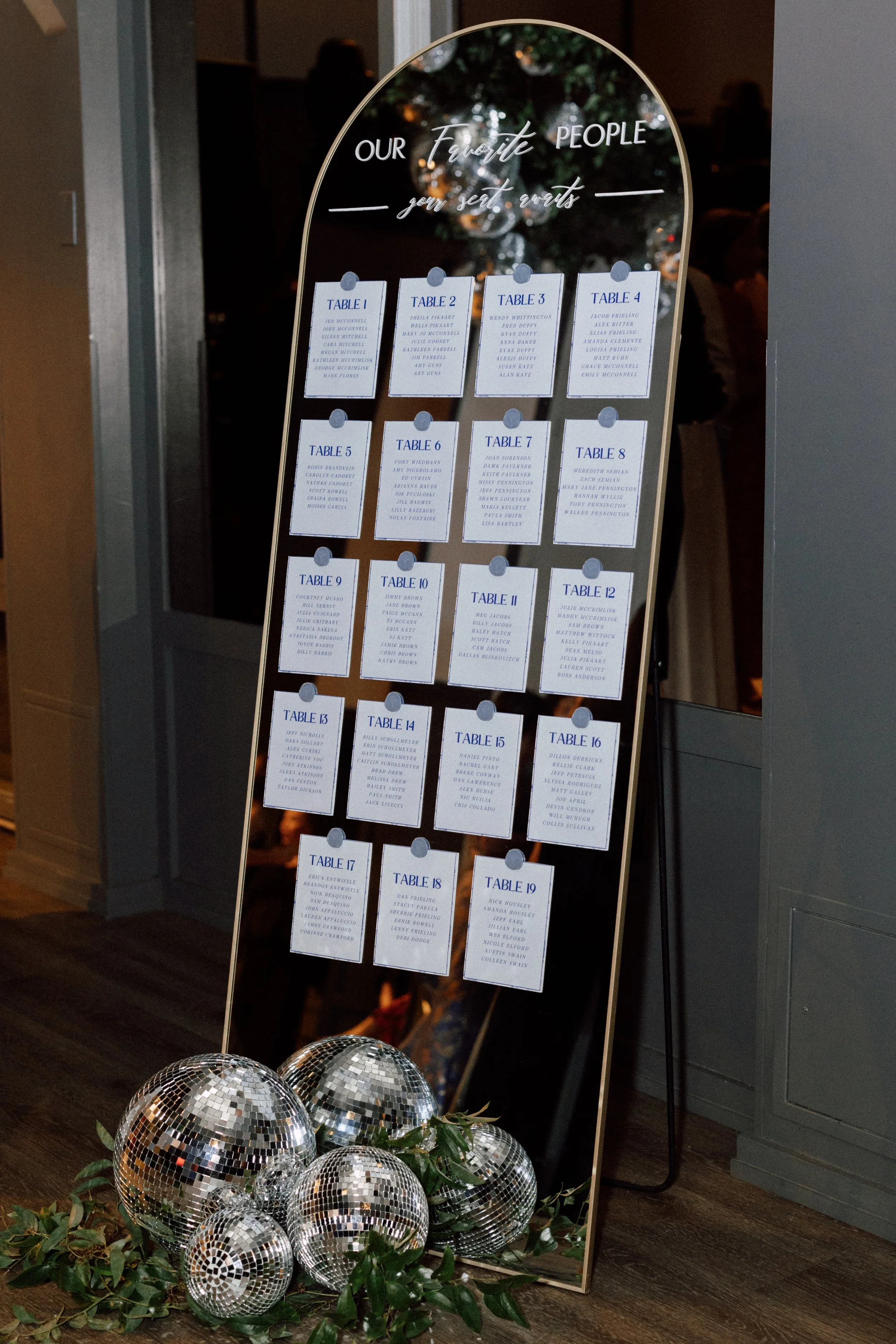 gold arched mirror seating chart disco balls.jpg