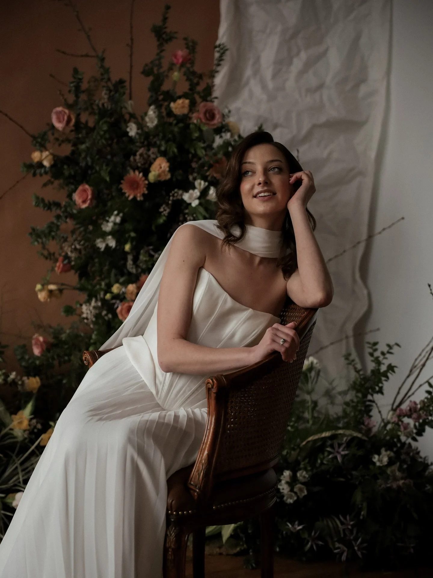 Creative direction for me isn&rsquo;t just styling a backdrop - it&rsquo;s shaping an atmosphere. I think about silhouette and scale, how the gown moves against the floor, how the florals frame the scene, how texture plays against texture. Structured