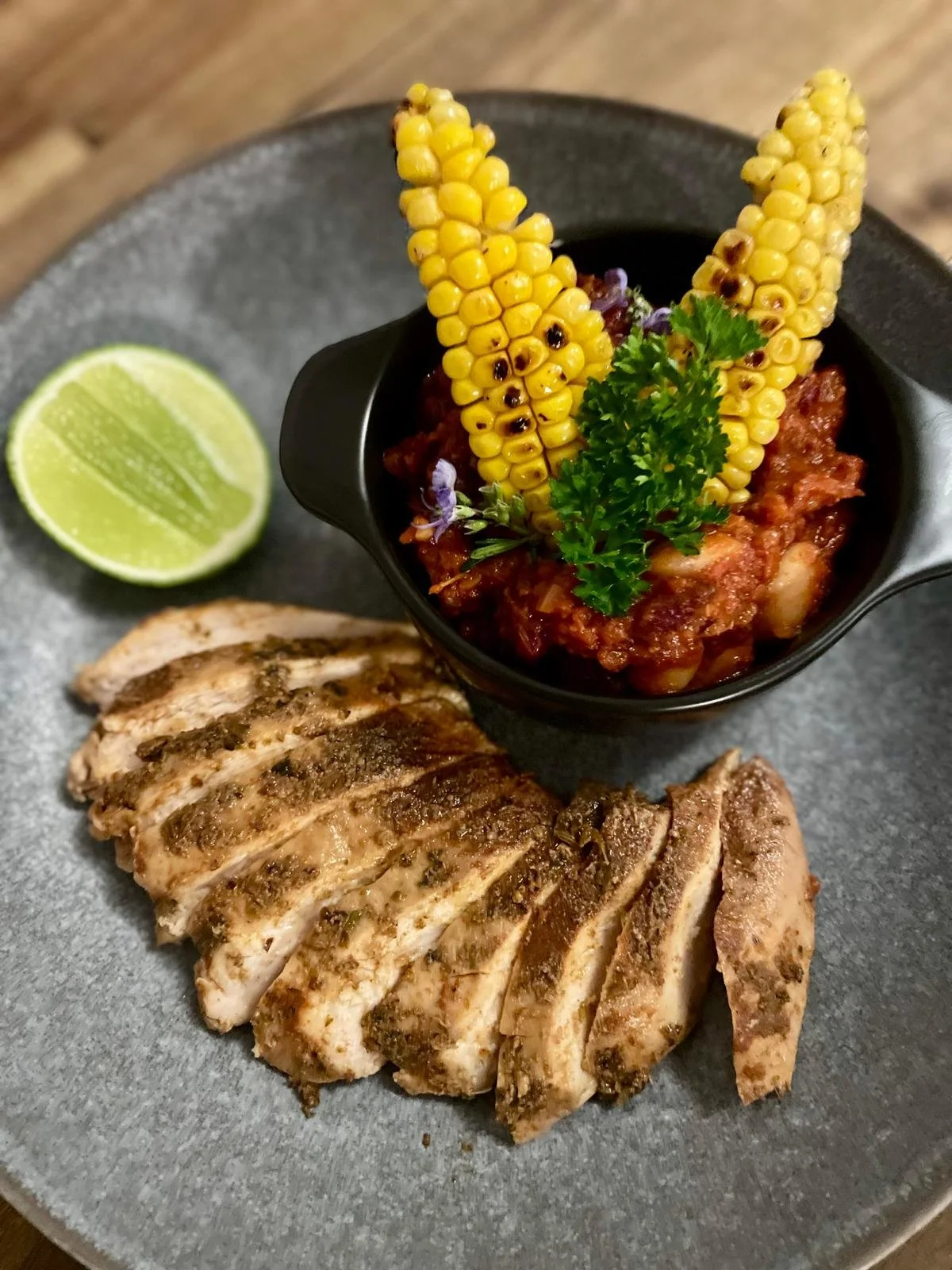 Sous Vide Spanish Chicken with charred corn, duo of beans and Chorizo