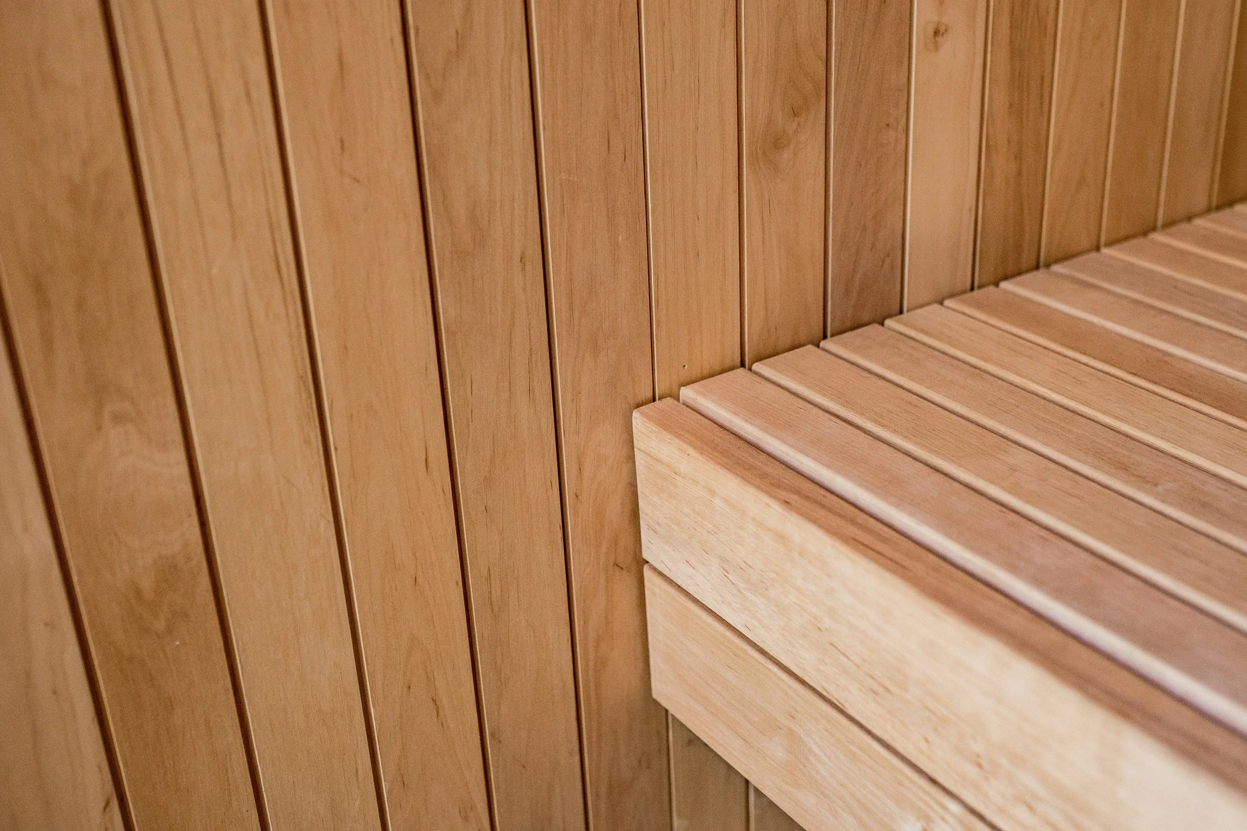 Close-up of a wooden wall and bench, that shows the craftmanship and accuracy of the builder who constructed it.