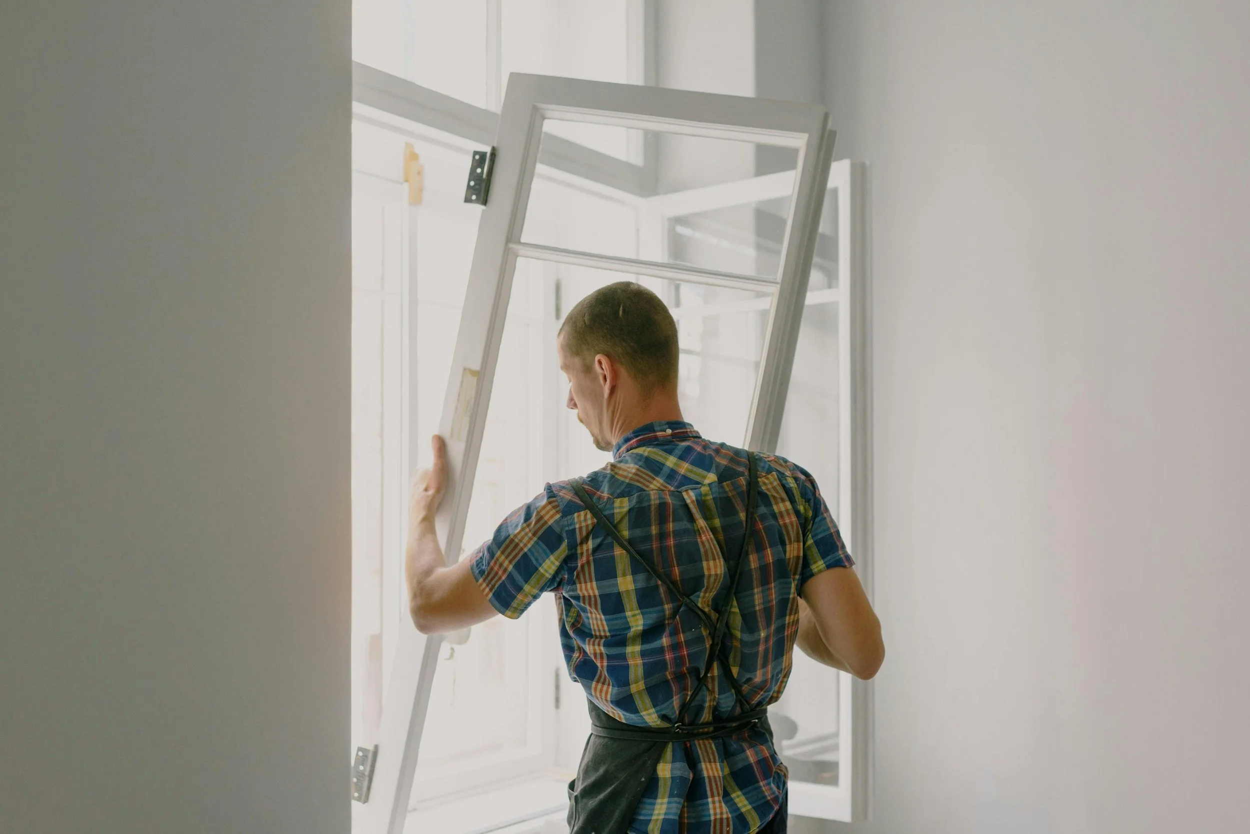 A builder installing or repairing a window.