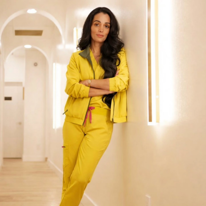 kamelia bahrini owner and director of near me therapy in langley bc standing in hallway leaning on wall with a confident smile