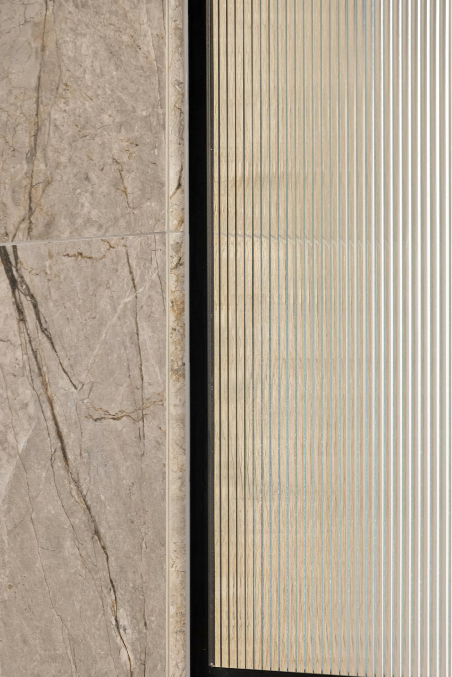 Close-up view of a tiled floor and a vent cover with horizontal slats.