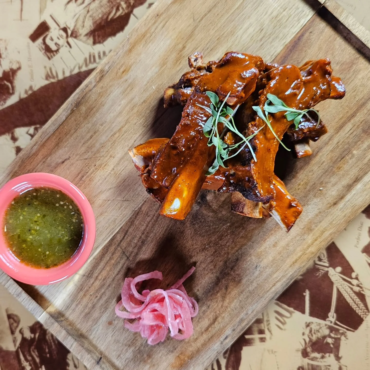 Costillas de Cerdo en BBQ de Guava &ndash;$18 Four tender, slow-braised pork ribs glazed with a tangy guava BBQ sauce, served with bright salsa verde and crisp pickled red onions for a perfect balance of sweet, smoky, and zesty flavors.*GF

#weekends