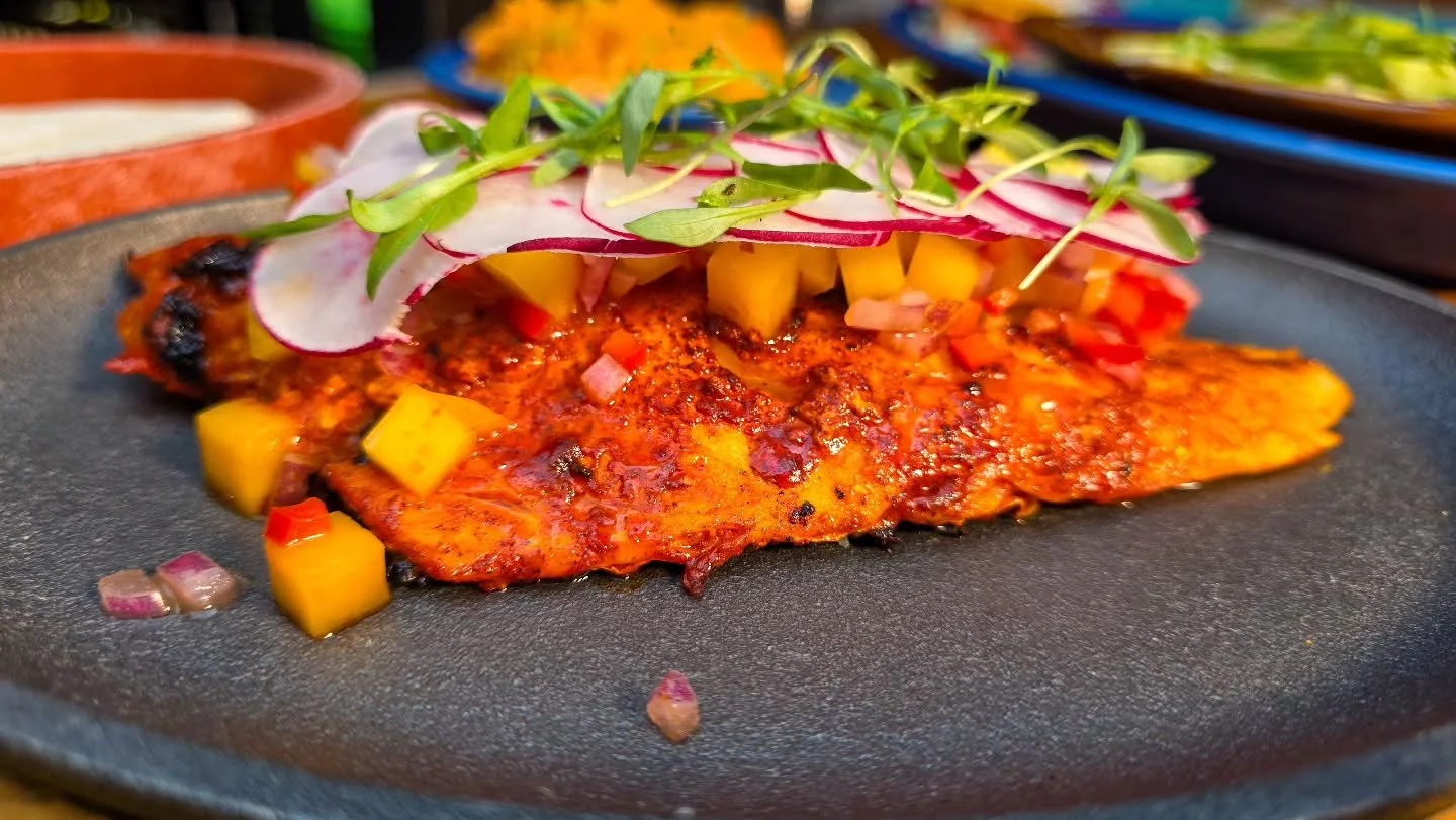 Pescado Zarandeado

Red snapper marinated in achiote, citrus, and smoky chiles, lightly charred and served with mango salsa warm tortillas and your choice of rice and beans fresh limeand herbs.

Available for a limited-time from the new Spring Menu

