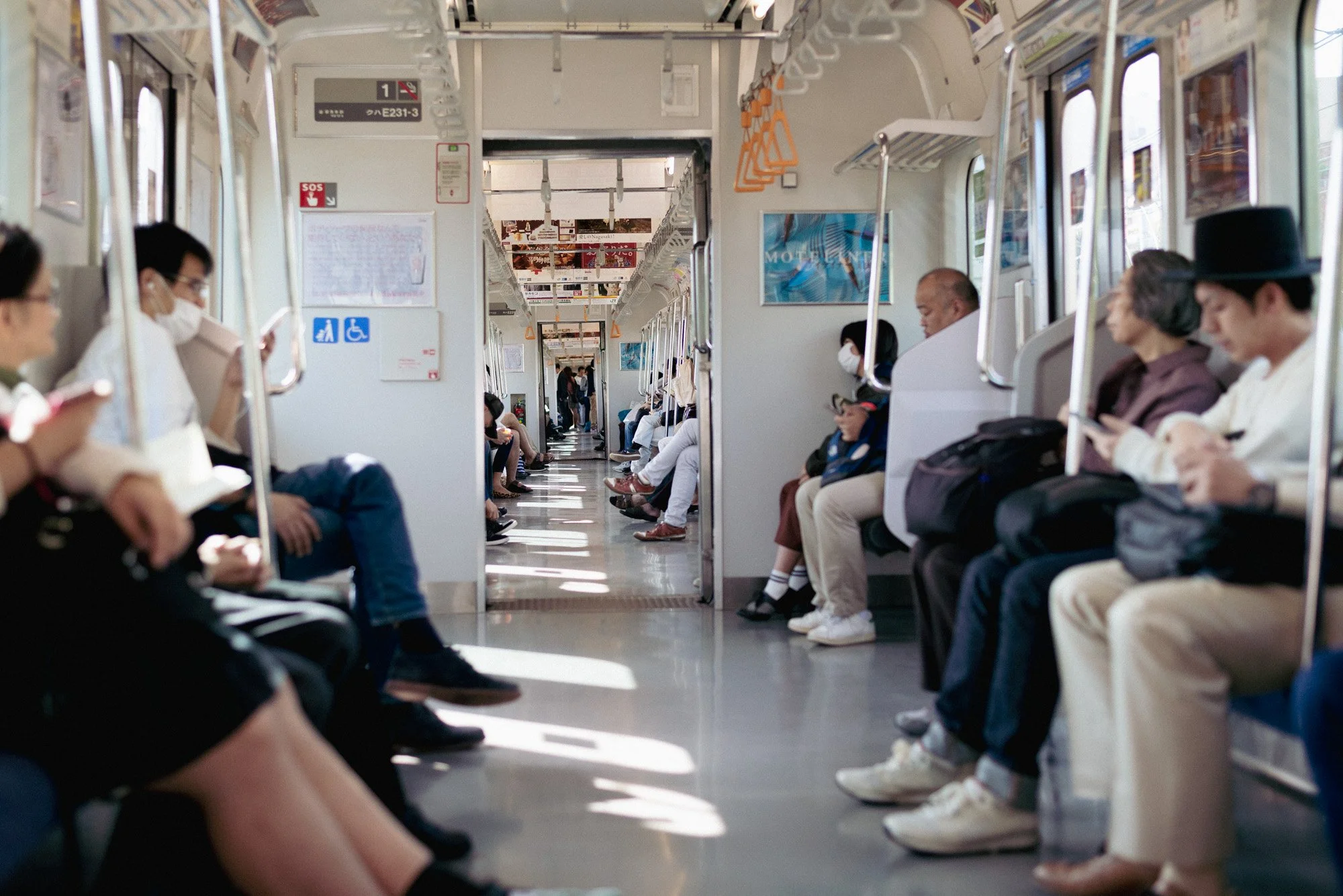 A bright and clean Tokyo Rail Car Interior, with Riders