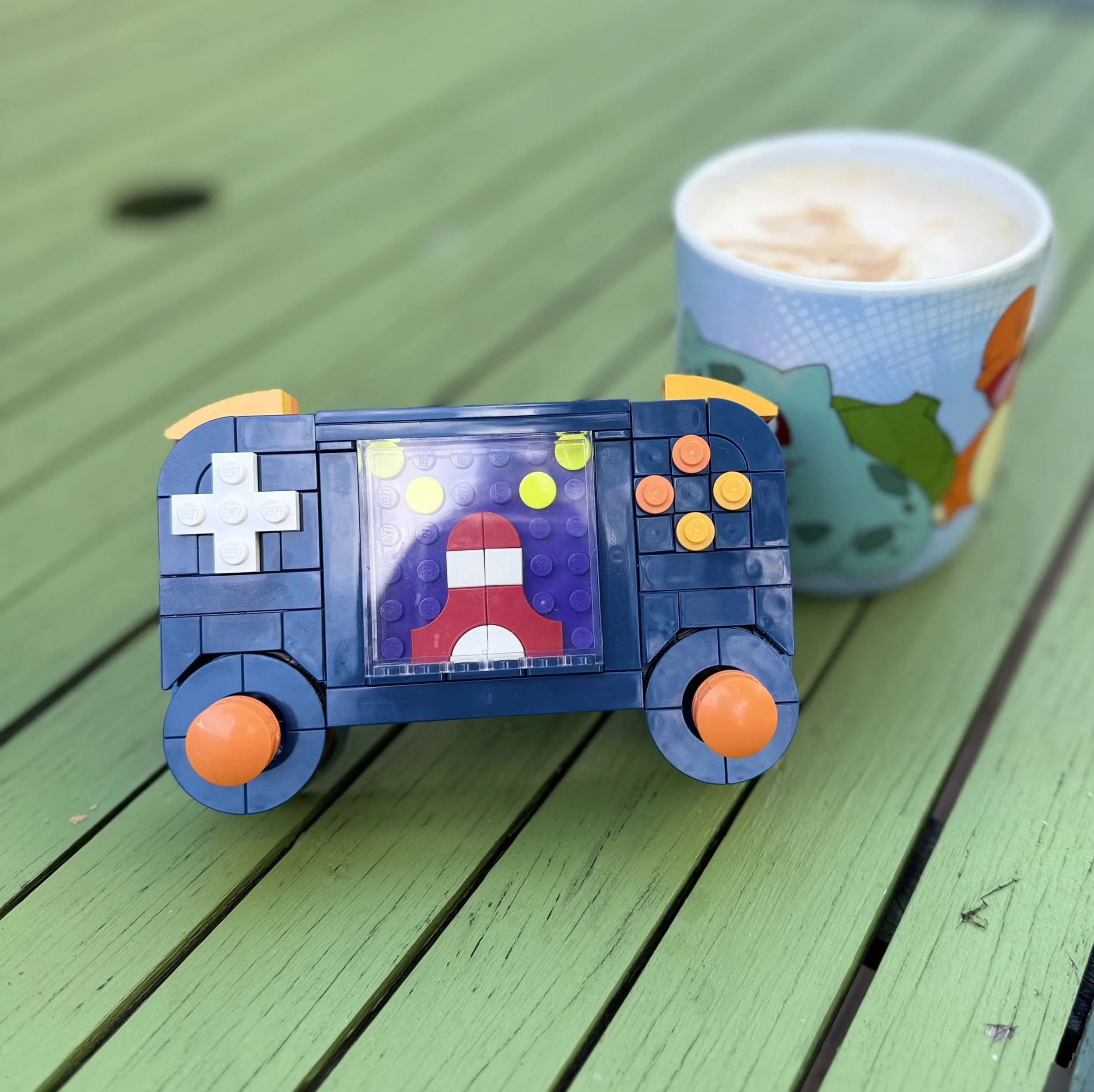 Lego game controller and cup of coffee
