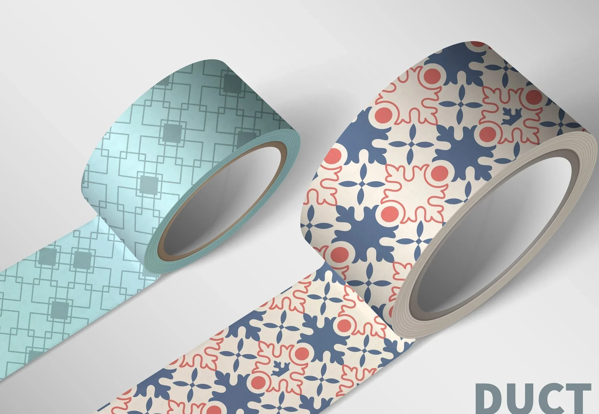 Two rolls of decorative adhesive tape with different patterns; one with a light blue geometric pattern and the other with a red and blue floral pattern, placed on a white surface.