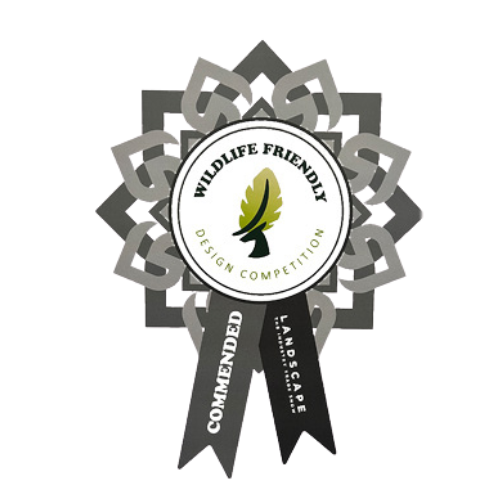 An award ribbon with a circular emblem in the center, featuring a green leaf and the words 'Wildlife Friendly Design Competition.' Beneath the emblem, black ribbons read 'Recommended' and 'Landscape.'