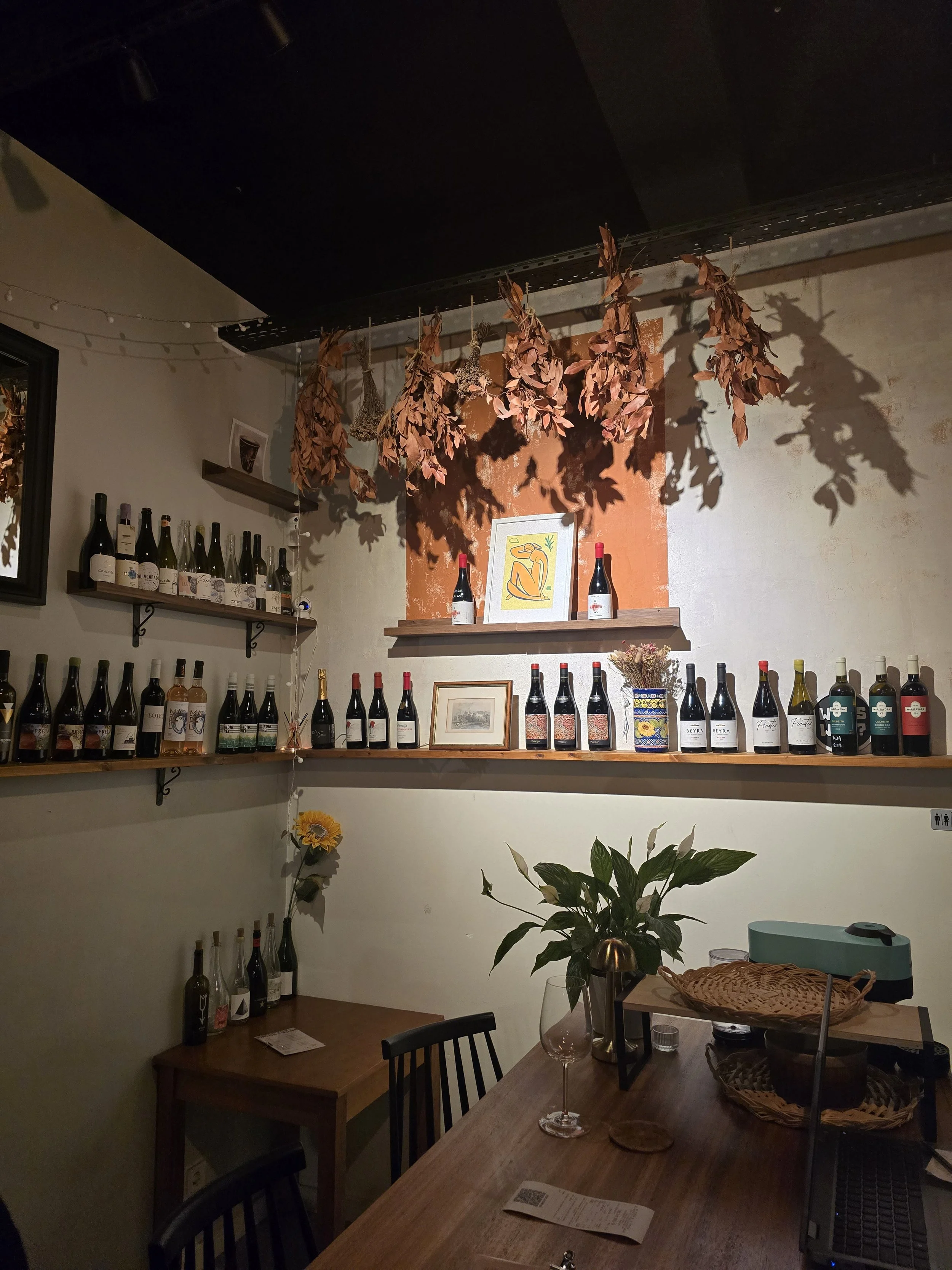 Bottles of wine lining shelves in a wine bar in Lisbon