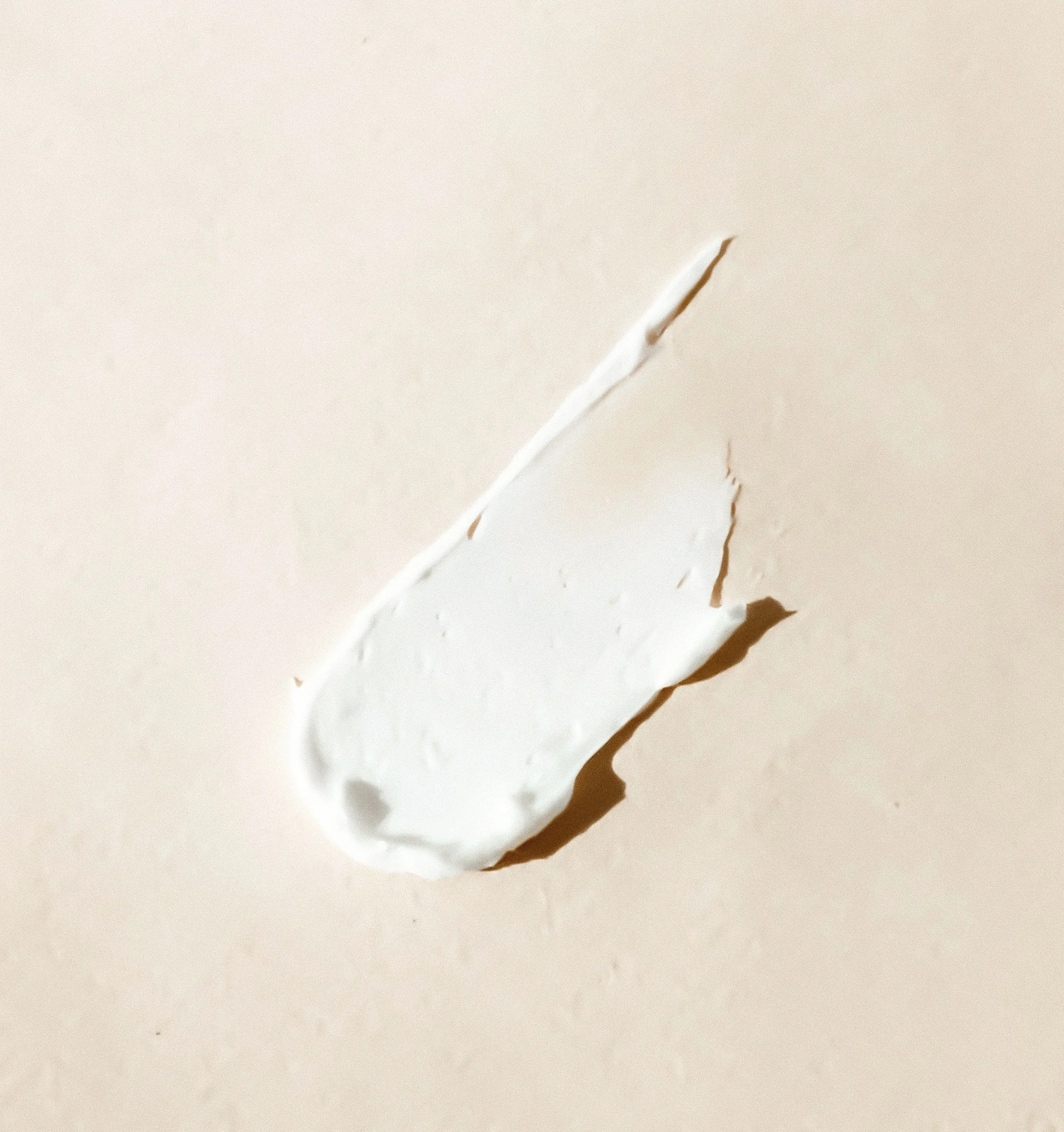 Smear of skincare cream on beige background
