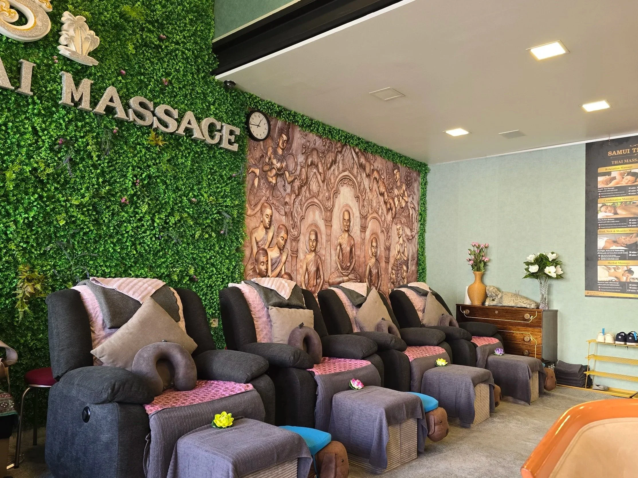 Row of armchairs for foot massage in a thai style salon