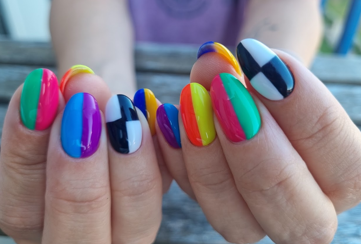 Professionally done bright multi-colored nails.