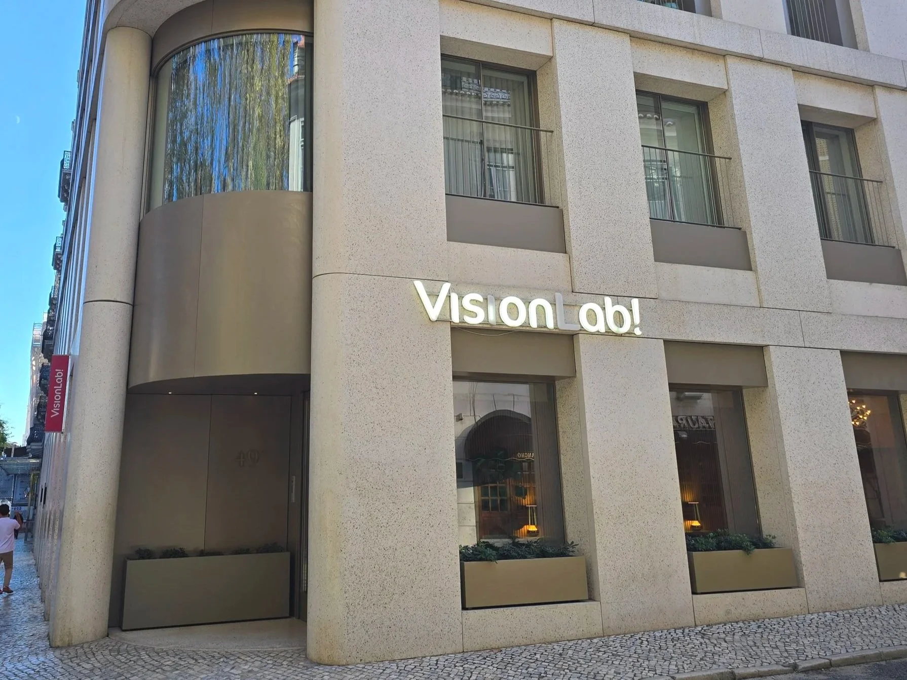 A modern building in Lisbon that has Vision Lab sign outside