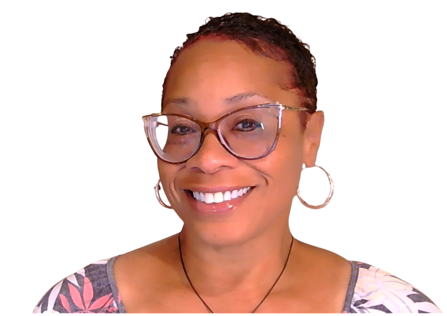 A woman with short curly hair, glasses, and earrings smiling at the camera, wearing a floral shirt.