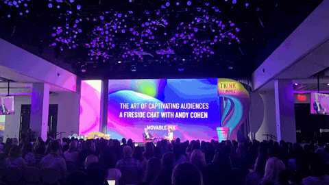 Andy Cohen Keynote screen and Think Summit Lava Lamp wall at event