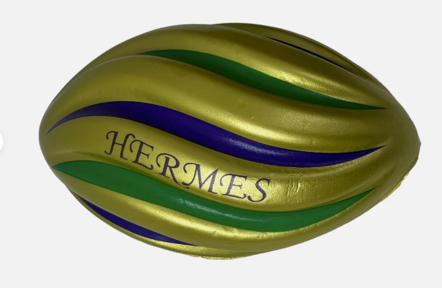A colorful Herrs mini chocolate egg with green, purple, and yellow stripes and the word "HERRMES" written on it.