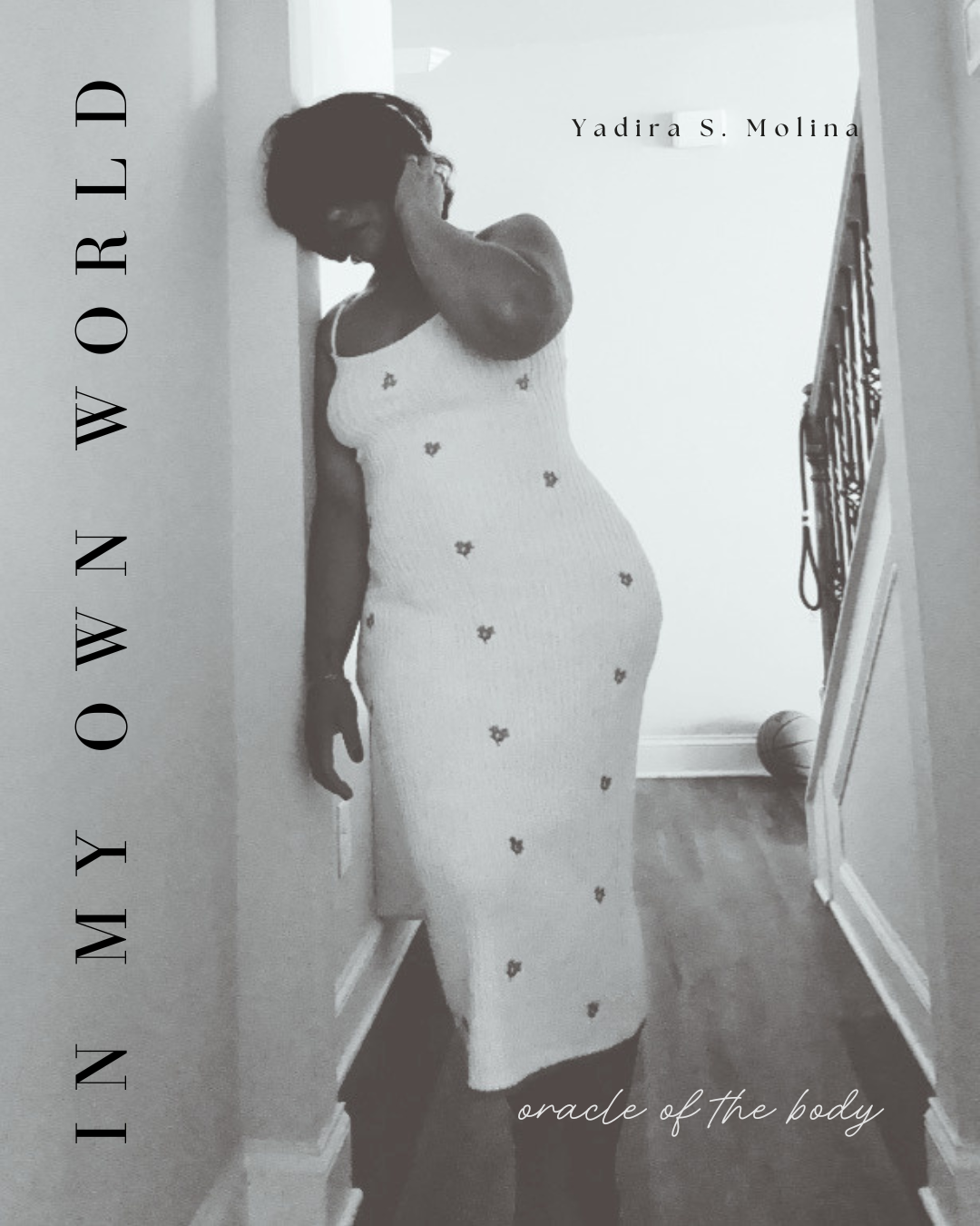 Book cover titled 'In My Own Worded' by Yadira S. Molina, with the subtitle 'oracle of the body,' featuring a black and white photo of a woman in a long, sleeveless dress, standing in a hallway.