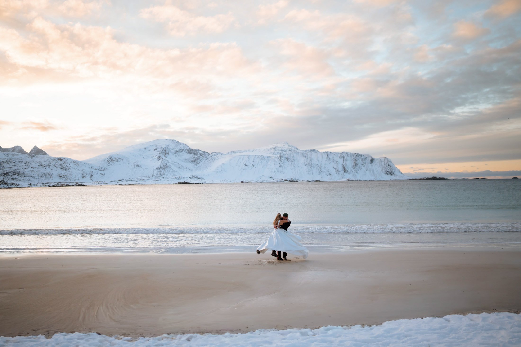 Couple eloping on scenic beach Northern Norway