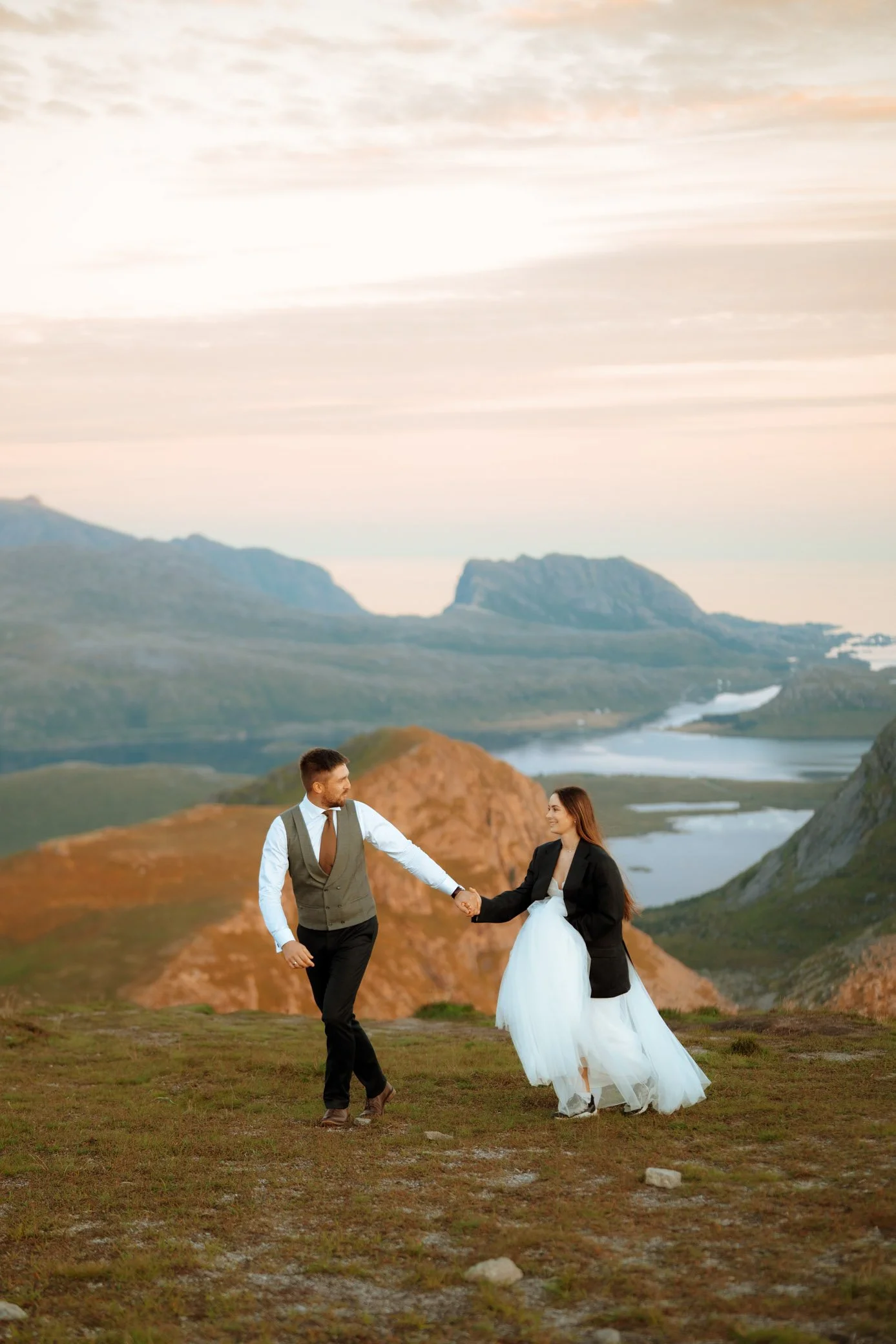 Couple walking in mountains during golden hour 