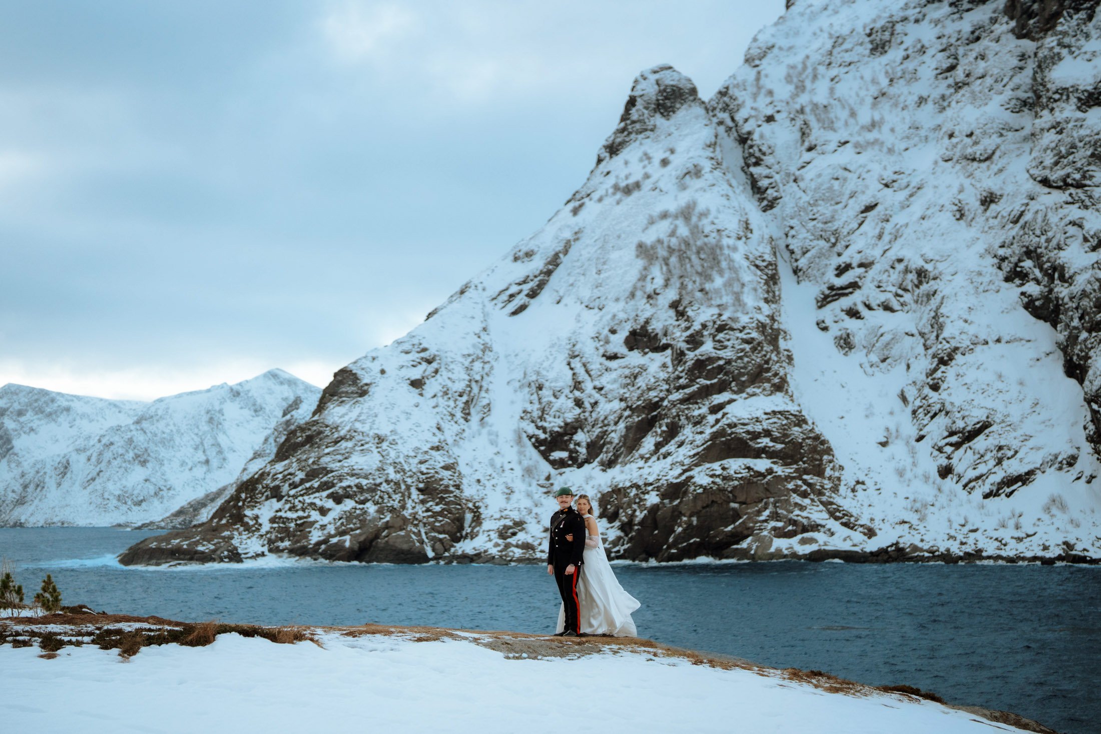 Bride and broom against dramatic mountains Northern Norway