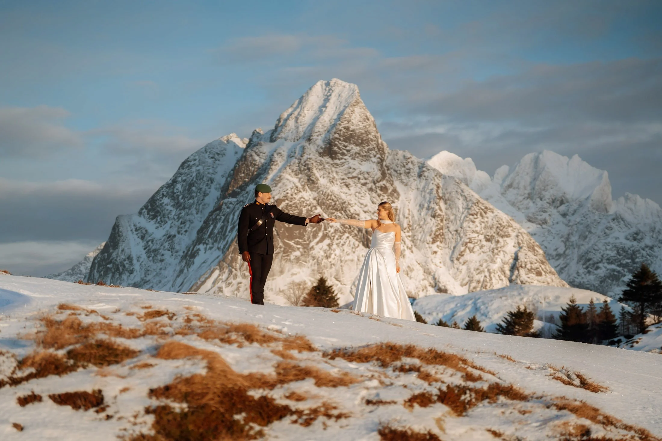 Couple during a winter wedding in Northern Norway - Lofoten surrounded by snowy mountains and Arctic landscape