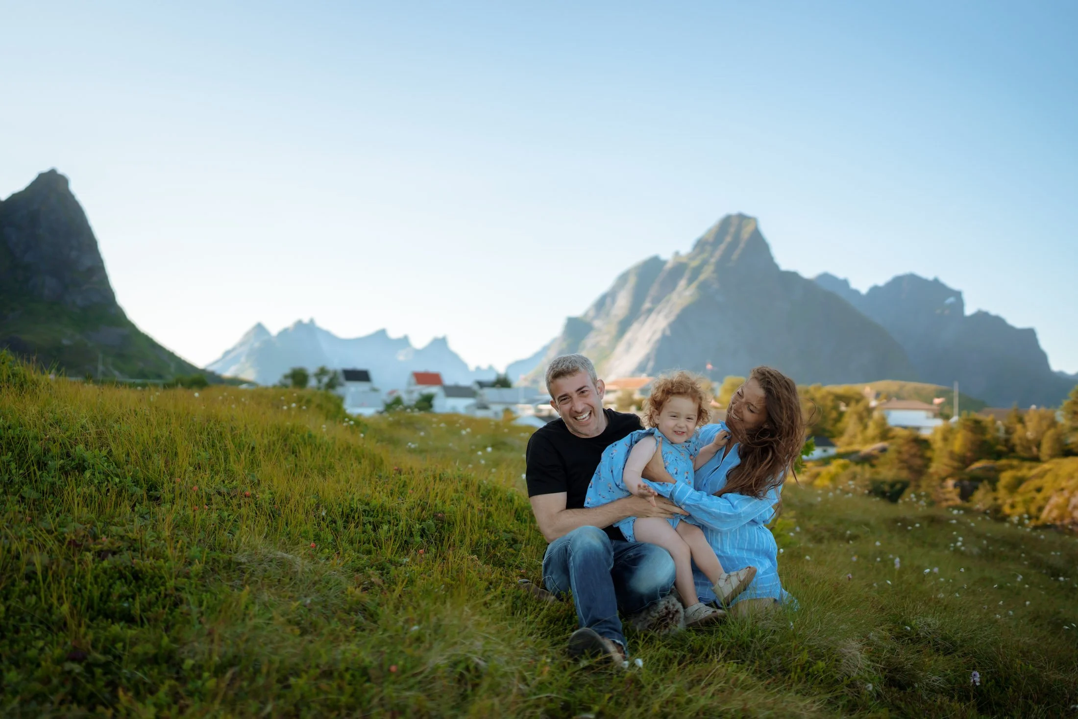 Family portrait in Lofoten with dramatic mountain backdrop
