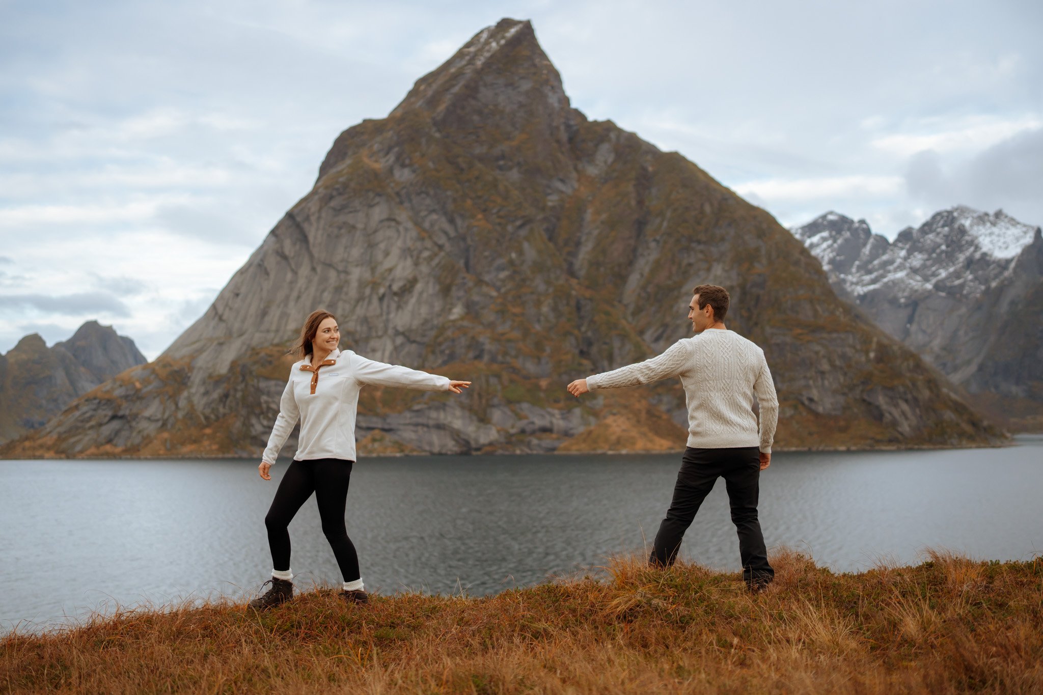 Couple photoshoot in Lofoten mountains with dramatic peaks and fjord views