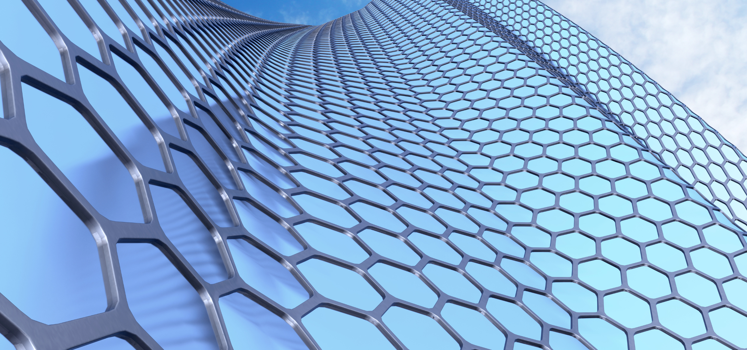 Looking up at a modern glass skyscraper with a honeycomb-patterned metal facade reflecting the sky.