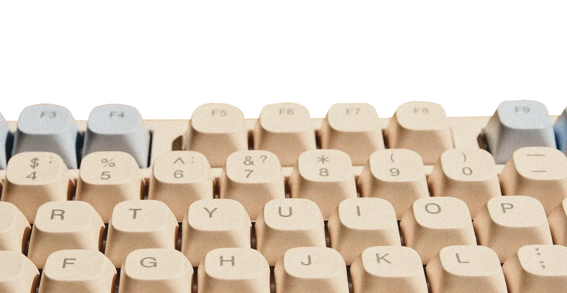 Close-up of a vintage beige computer keyboard showing the top row of keys, including F1 to F12, along with number keys and symbols.