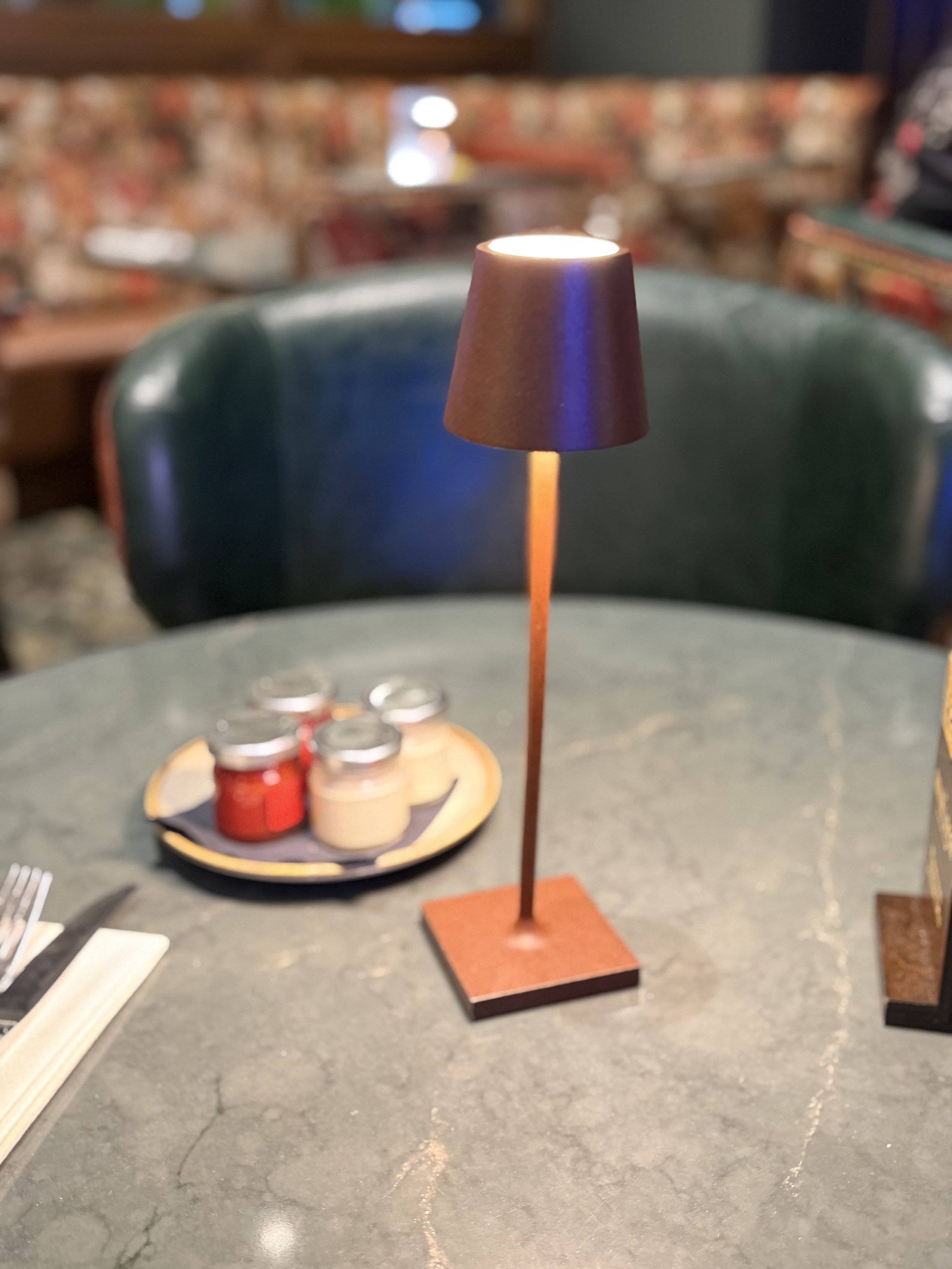 Hilton Dublin bar with green leather seating and copper table lamp