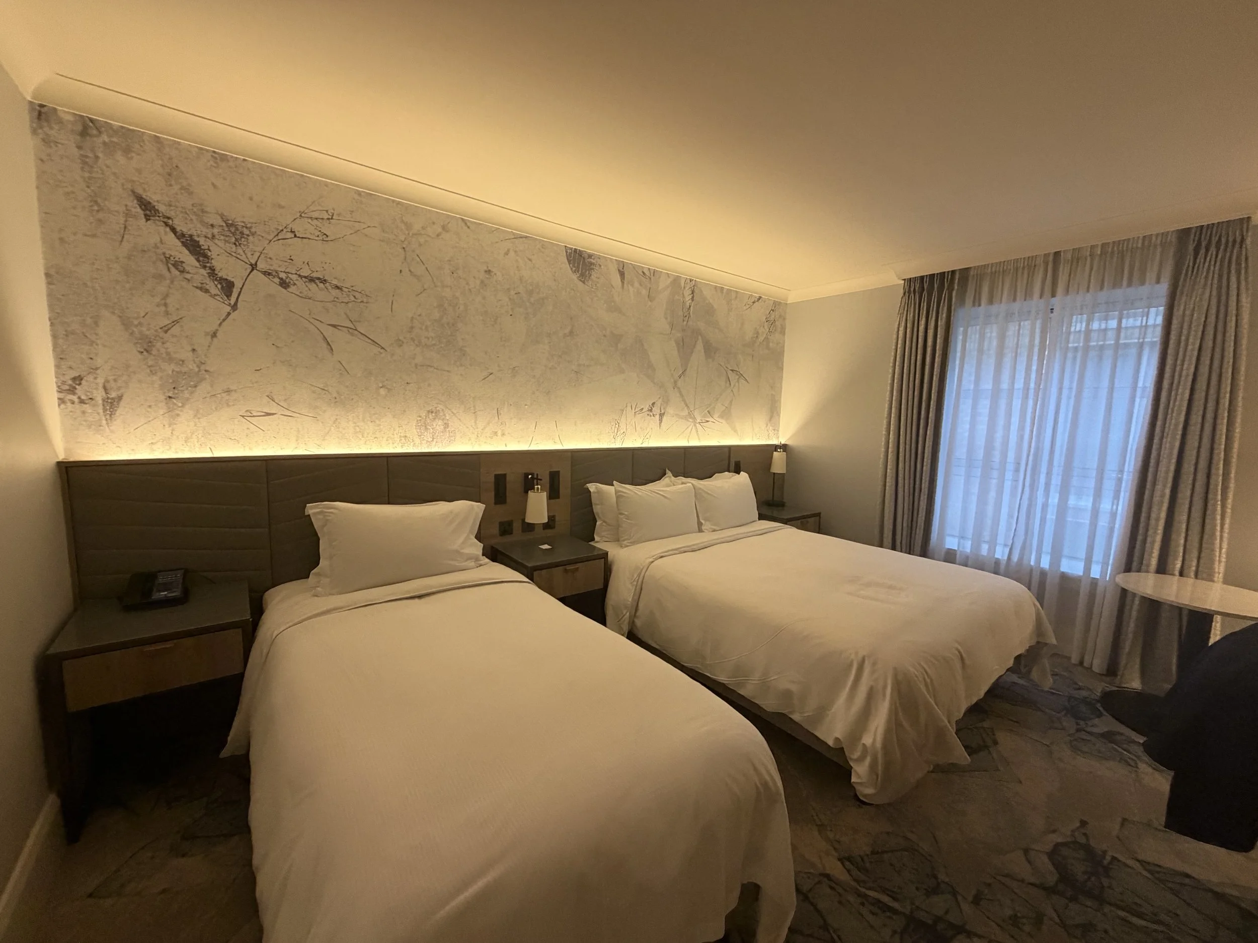 Hilton Dublin twin guest room with pressed-leaf print wall