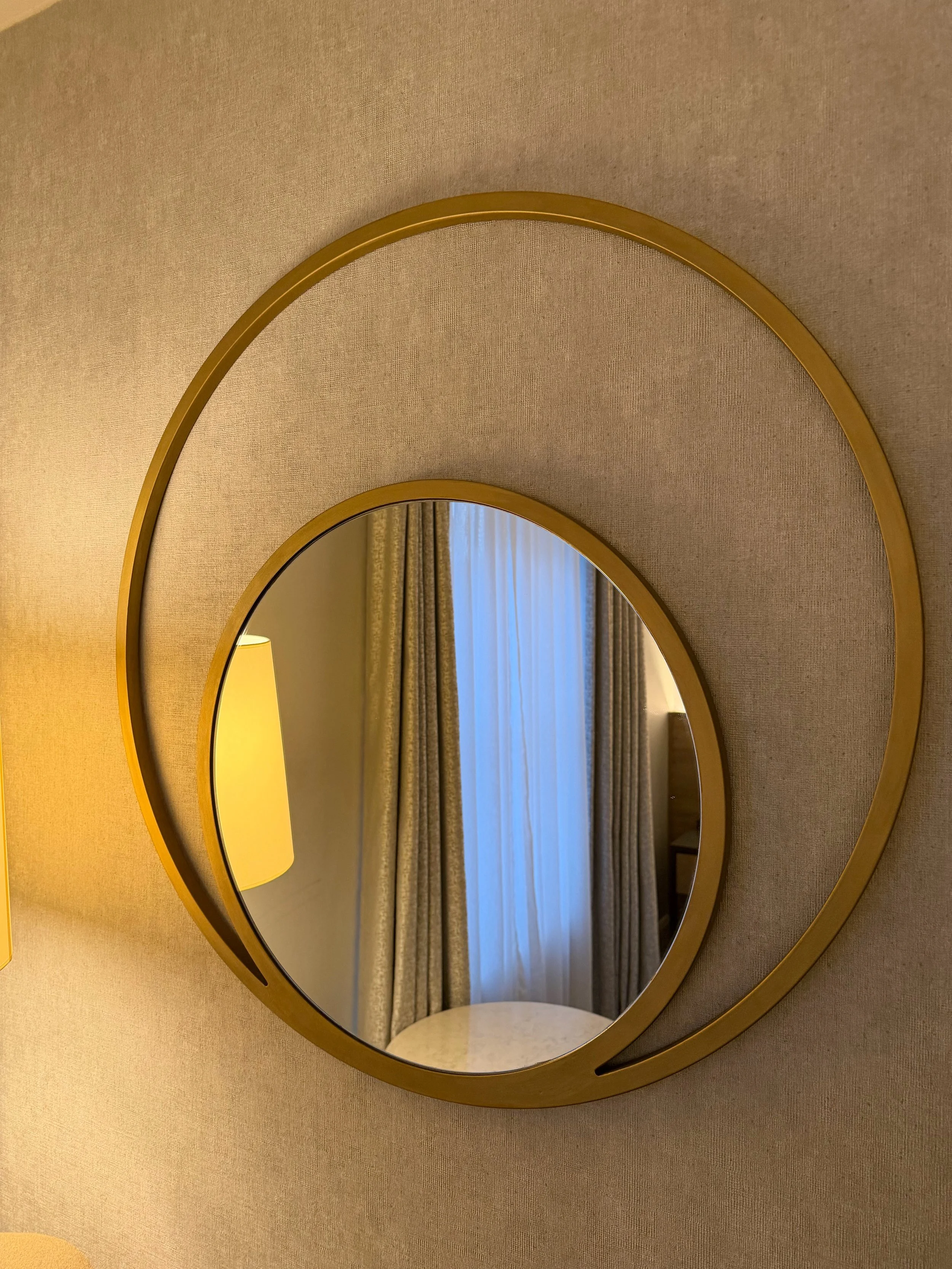 Hilton Dublin gold round mirror within a larger circle