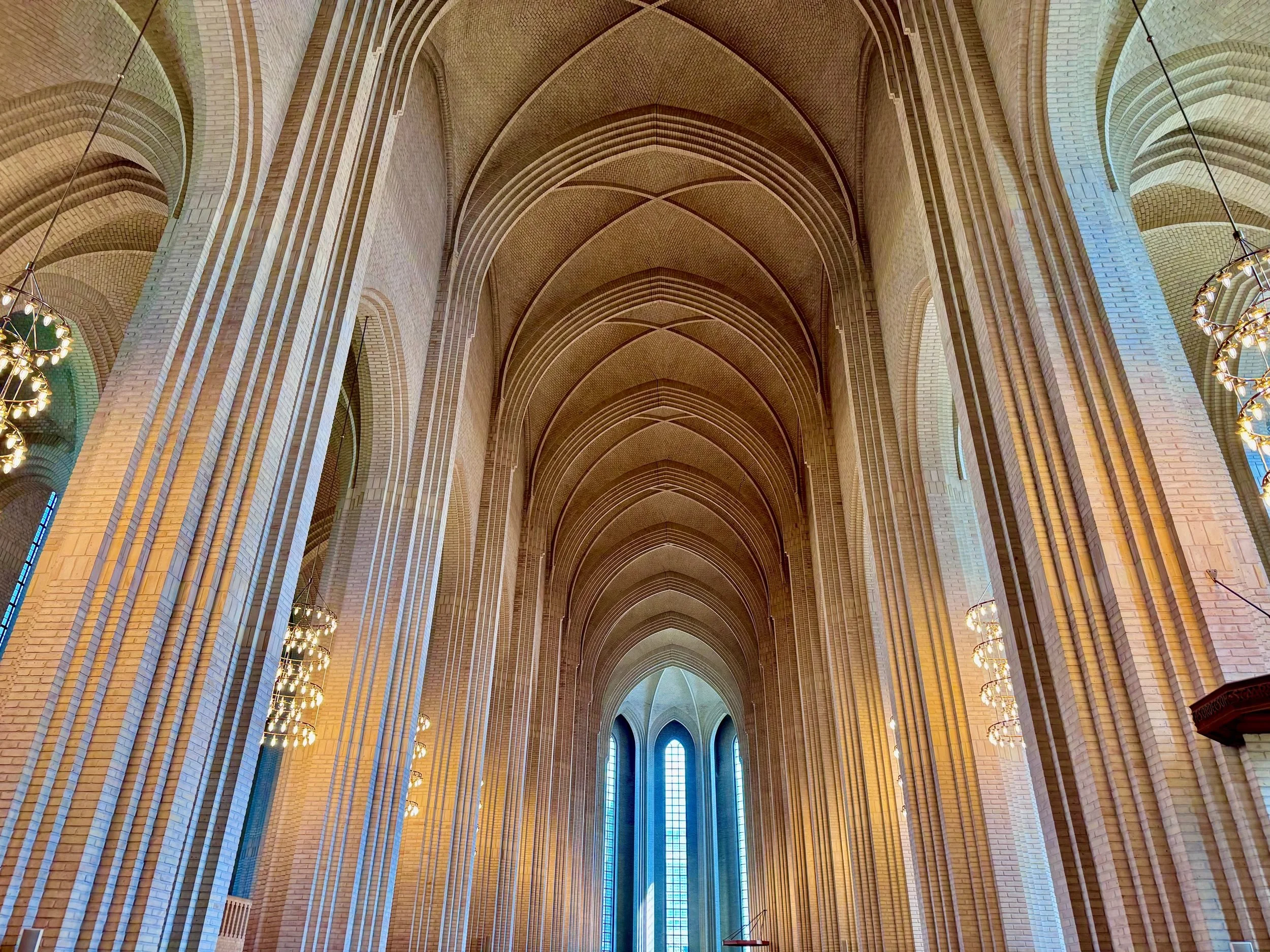 The nave of Grundtvig's Church, Copenhagen, in yellow brick and soft light.